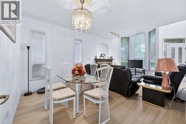 Foyer with a large chandelier, white railings, and a staircase leading to the second floor. - 6 8693 No. 3 Road, Richmond