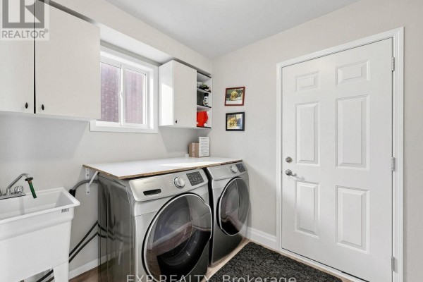 Side-by-side washer and dryer with utility sink and cabinets - 6 Booth Lane Barrie