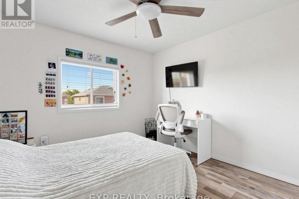 Bedroom with ceiling fan, mounted TV, and desk - 6 Booth Lane Barrie