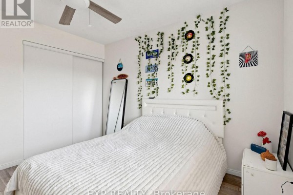 Bedroom with white tufted headboard, faux ivy vines, vinyl records & license plates - 6 Booth Lane Barrie