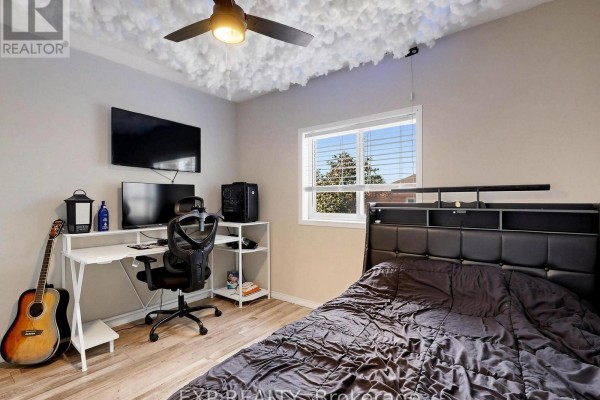 Bedroom with cloud ceiling decor, desk, TV, and bed - 6 Booth Lane Barrie