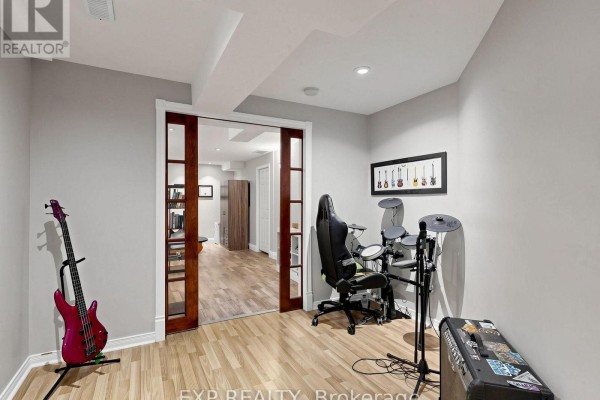 Electric guitar, drum set, and gaming chair in a modern room - 6 Booth Lane Barrie