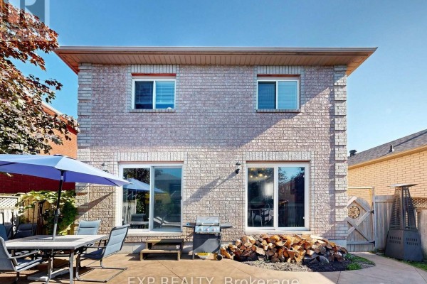 Backyard with patio furniture, grill, firewood, and umbrella - 6 Booth Lane Barrie