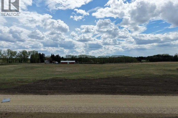 Aerial view of a larger parcel of land outlined in red, with nearby structures. - #6 C&e Trail North Of Blackfalds, Rural Lacombe County
