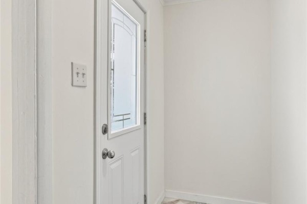 Interior view of a white entry door with a frosted glass panel and silver knob. - 6 Cherry Hill Road, St  John S