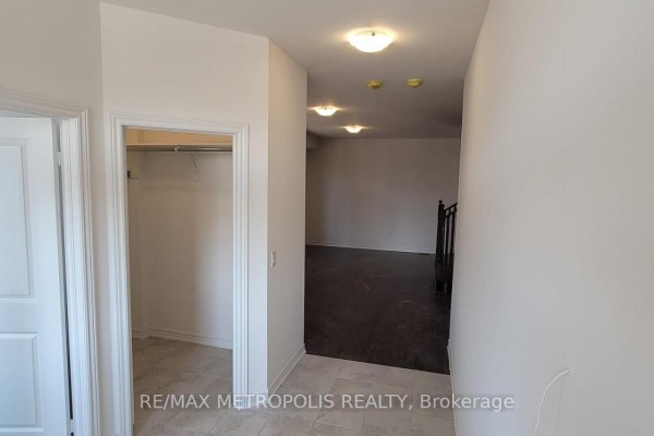 Hallway with tiled floor, closet on the left, and view into a darker room beyond. - 6 Corbett Street, Southgate