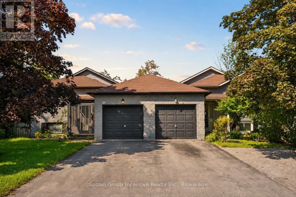 Front exterior of 6 Donald Crescent, Wasaga Beach with two garage doors and brick accents. - 6 Donald Crescent, Wasaga Beach