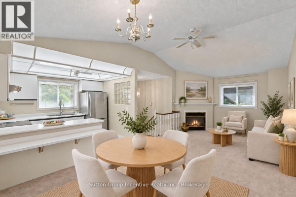 Dining area with table and chairs, connected to the kitchen, with double glass doors. - 6 Donald Crescent, Wasaga Beach