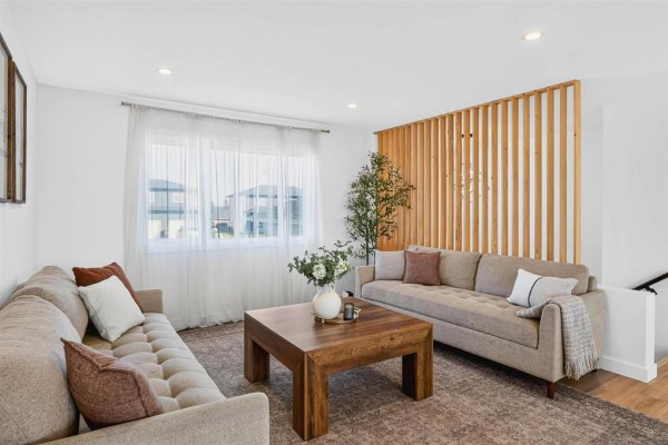 Living room with two beige sofas, a wooden coffee table, and sheer curtains on a large window. - 6 Falcon Bay, Ste Anne