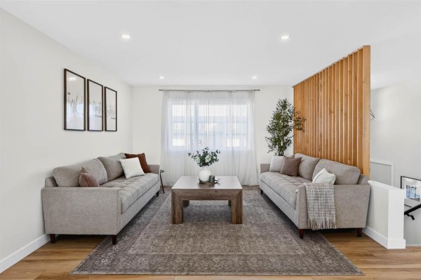 Living room featuring two tufted sofas, a wood coffee table, and a slatted wood divider. - 6 Falcon Bay, Ste Anne