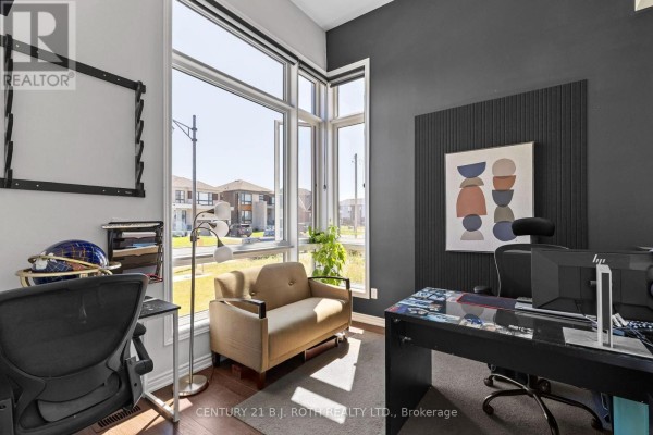 Home office with large windows, a desk, chair, sofa, and artwork on dark wall. - 6 Henderson Street, Essa