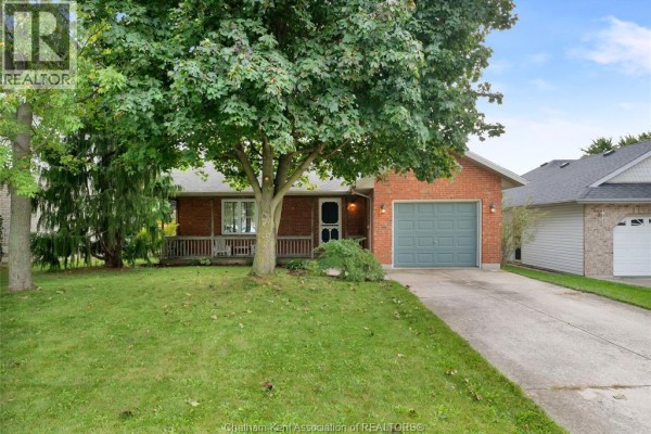 Front view of a brick bungalow with a covered front porch and mature trees. - 6 James Street, Blenheim