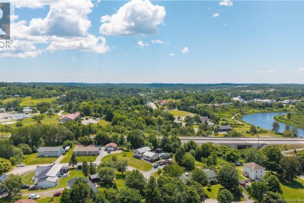 Aerial view of the property with surrounding landscape and nearby highway. - 6 Kennedy Court, St George