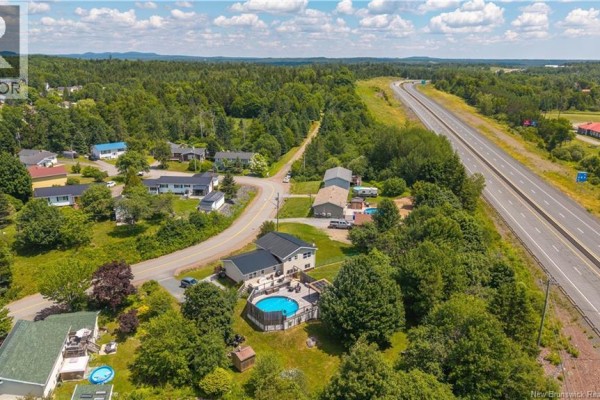 Aerial view highlighting the house's location near the highway and surrounding neighborhood. - 6 Kennedy Court, St George