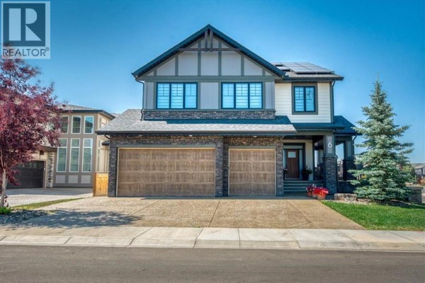 Aerial view of a residential neighborhood with rows of houses and a large park in the background. - 6 Legacy Woods Crescent Se, Calgary