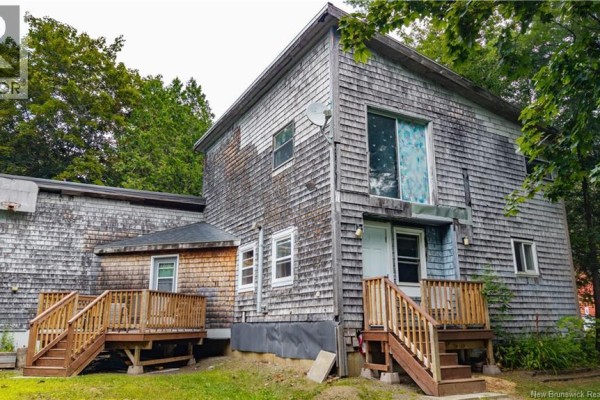 Back view of the home showing multiple levels, wood shingle siding, and wooden decks. - 6 Parkwood Drive, St  Stephen