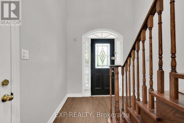 Exterior front view of a two-story brick house with a paved driveway and green landscaping. - 6 Purdy Crescent W, Toronto