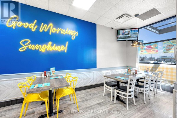 Exterior storefront of Eggsmart restaurant with large windows and a yellow sign. - 6 Rylander Boulevard, Toronto