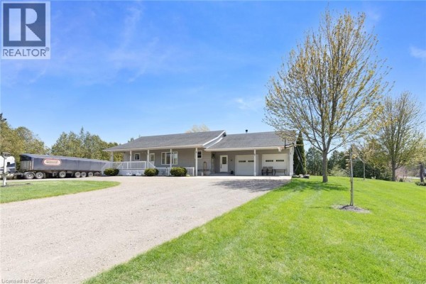 Exterior rear view of a ranch house with a covered porch, white railings, steps, and gravel driveway. - 6 Scott Street, Delhi