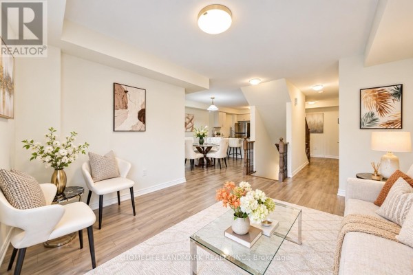 Interior hallway with light wood floors, white walls, and a staircase with wood banister. - 6 Sedgemoor Street, Whitby