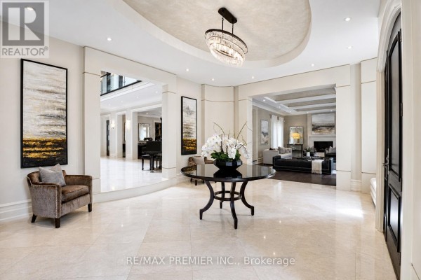 Foyer featuring a grand piano, seating areas, artwork, and views into adjoining living spaces. - 6 The Bridle Path, Toronto