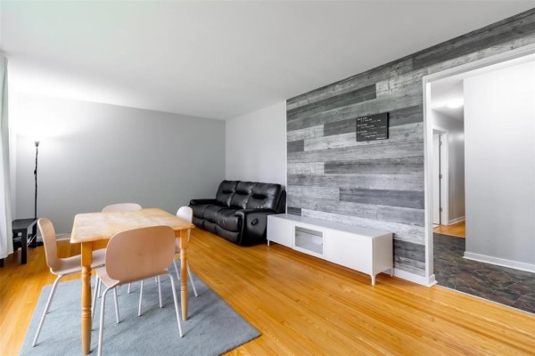 Interior view of living and dining area with a sofa, dining table, and view into hallway. - 6 Tulane Bay, Winnipeg