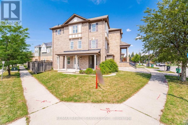 Angle view of a brick townhouse with a front lawn and intersecting sidewalks. - 6 Viewforth Road, Brampton