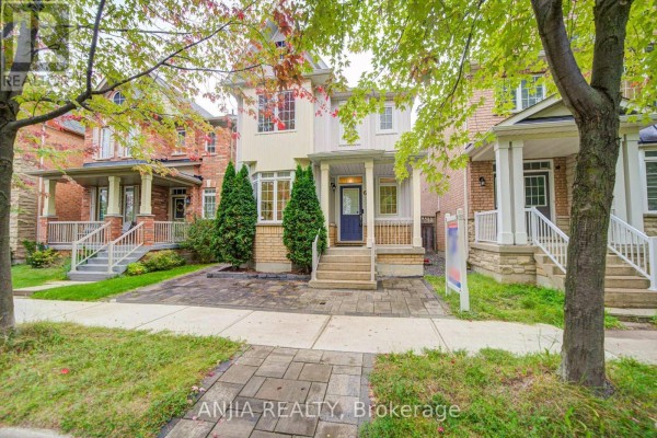 Exterior view of the house at 6 Wildmoor Street with manicured trees and walkway. - 6 Wildmoor Street, Markham