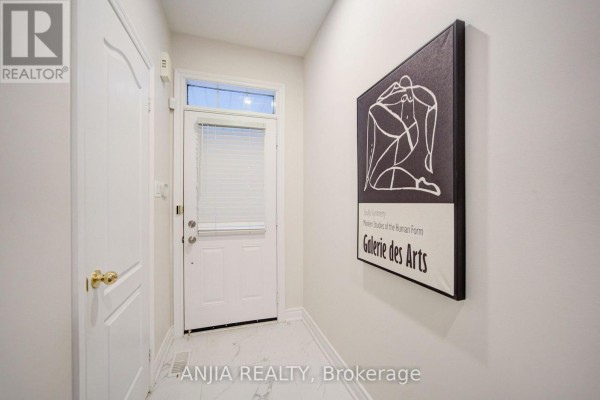 Interior entryway with white walls, marble tile floor, and artwork on the wall. - 6 Wildmoor Street, Markham