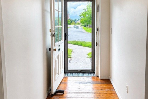View from inside looking out the open front door to a sidewalk and street. - 6 Willard Street, Belleville