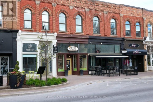 Row of shops on Hurontario Street, including Foundry and other businesses with awnings and signage. - 60, 62, 64 Hurontario Street, Collingwood