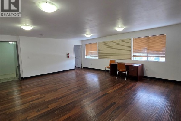 Bright room with wooden floors, desk, and window blinds - 60 1932 St George Avenue, Saskatoon