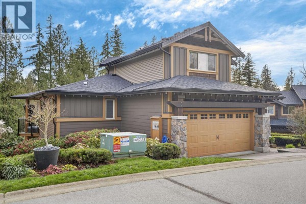 Rear exterior of a townhouse with a walk-out deck, patio area, and grassy sloped yard. - 60 24185 106b Avenue, Maple Ridge