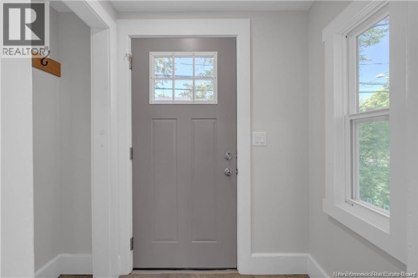 Interior view of a gray door and adjacent window in a home entryway. - 60-62 Queensway, St  Stephen
