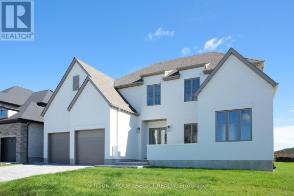 Side angle of the house featuring large windows and a two-car garage. - 60 Bayshore Drive, Middlesex Centre
