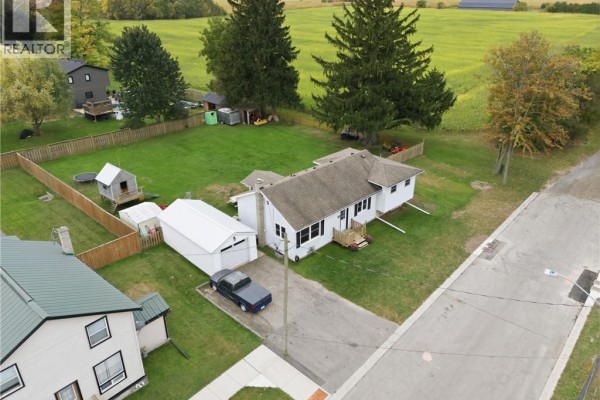 High aerial view of the property showing the bungalow, garage, and backyard amenities. - 60 Railway Street W, Princeton