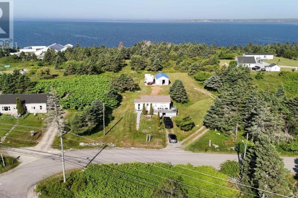 Aerial view of multiple houses and RVs on a hill overlooking a large bay with scattered islands. - 60 Red Schoolhouse Lane, North East Point