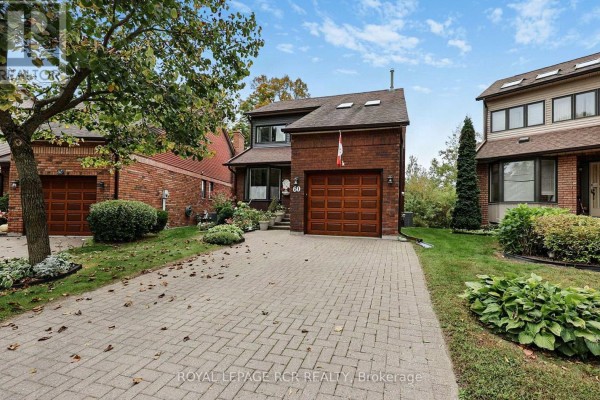 Exterior view of the house at 60 Riverview Road from the street, showing the front door and garage. - 60 Riverview Road, New Tecumseth