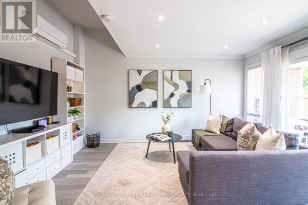 Living room with a sectional sofa, coffee table, and a window with white curtains. - 60 Springfair Avenue, Aurora