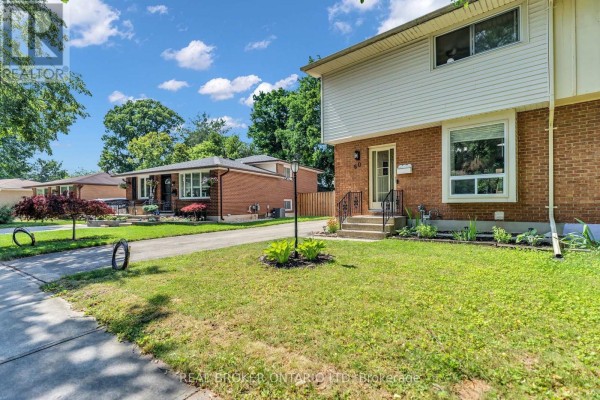 View of the front of the house and neighboring homes on a tree-lined street. - 60 Tilipe Road, London East