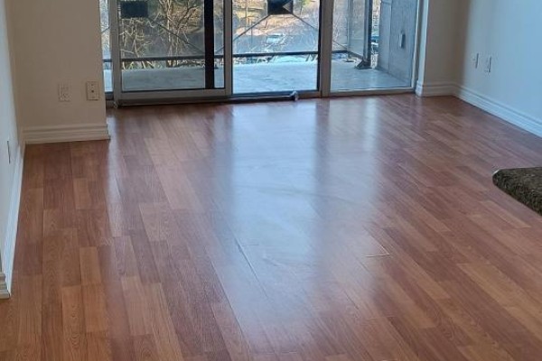 Living room with laminate flooring and sliding glass door to balcony. - 601 - 133 Wynford Drive, Toronto