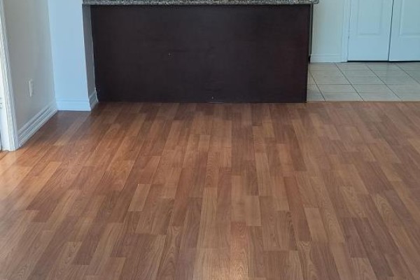 View of kitchen island and dining area with laminate flooring. - 601 - 133 Wynford Drive, Toronto
