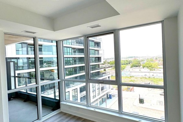 Corner windows with a city view and modern building architecture. - 601 - 20 Deans Drive, Toronto