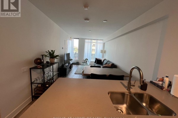 Open concept living and dining area with kitchen island and view of the street. - 601 - 411 Mackay Street, Ottawa