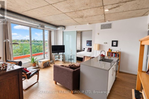 Living space with a sliding glass door to a bedroom and a city view. - 602 - 1000 Wellington Street W, Ottawa