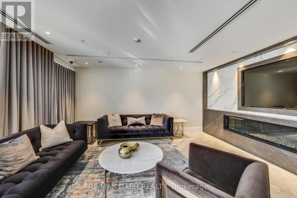 Spacious living room with natural light, hardwood floors, and a view of the city - 602 - 151 Avenue Road, Toronto