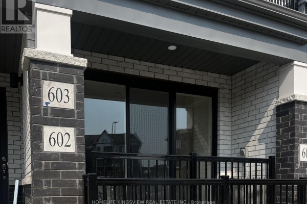 Close-up of townhouse entrances for units 602 and 603 with dark brick pillars and numbered signage. - 602 - 160 Densmore Road, Cobourg