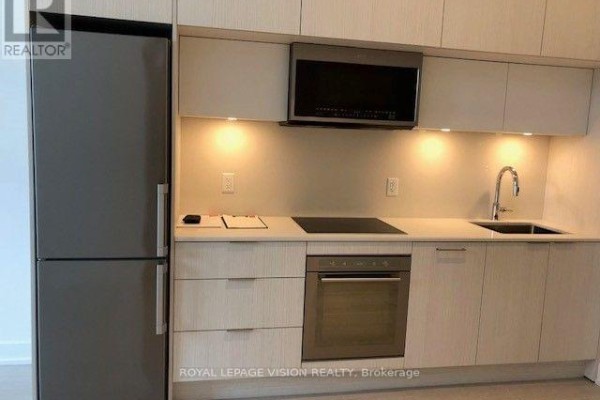 Full view of the kitchen area including a modern stainless steel refrigerator. - 602 - 25 Adra Grado Way, Toronto