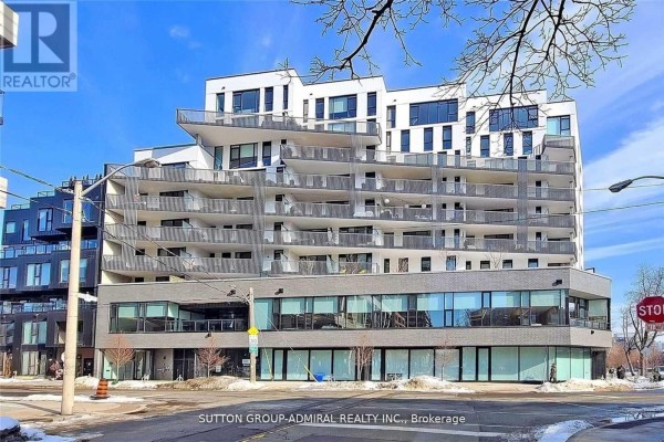 Exterior view of a modern apartment building with balconies and large glass windows. - 602 - 41 Dovercourt Road, Toronto