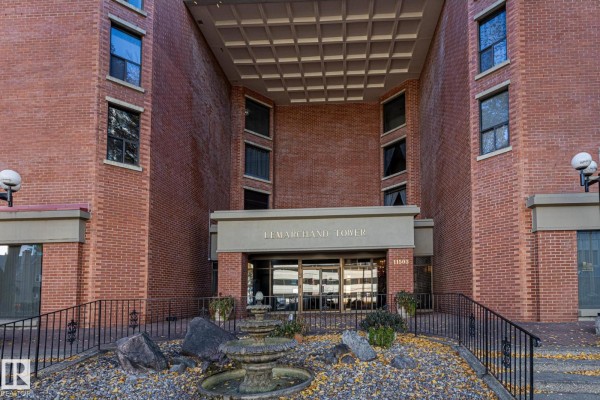 Lobby area with wooden paneling, chandelier, and leather seating. - #602 11503 100 Av Nw, Edmonton